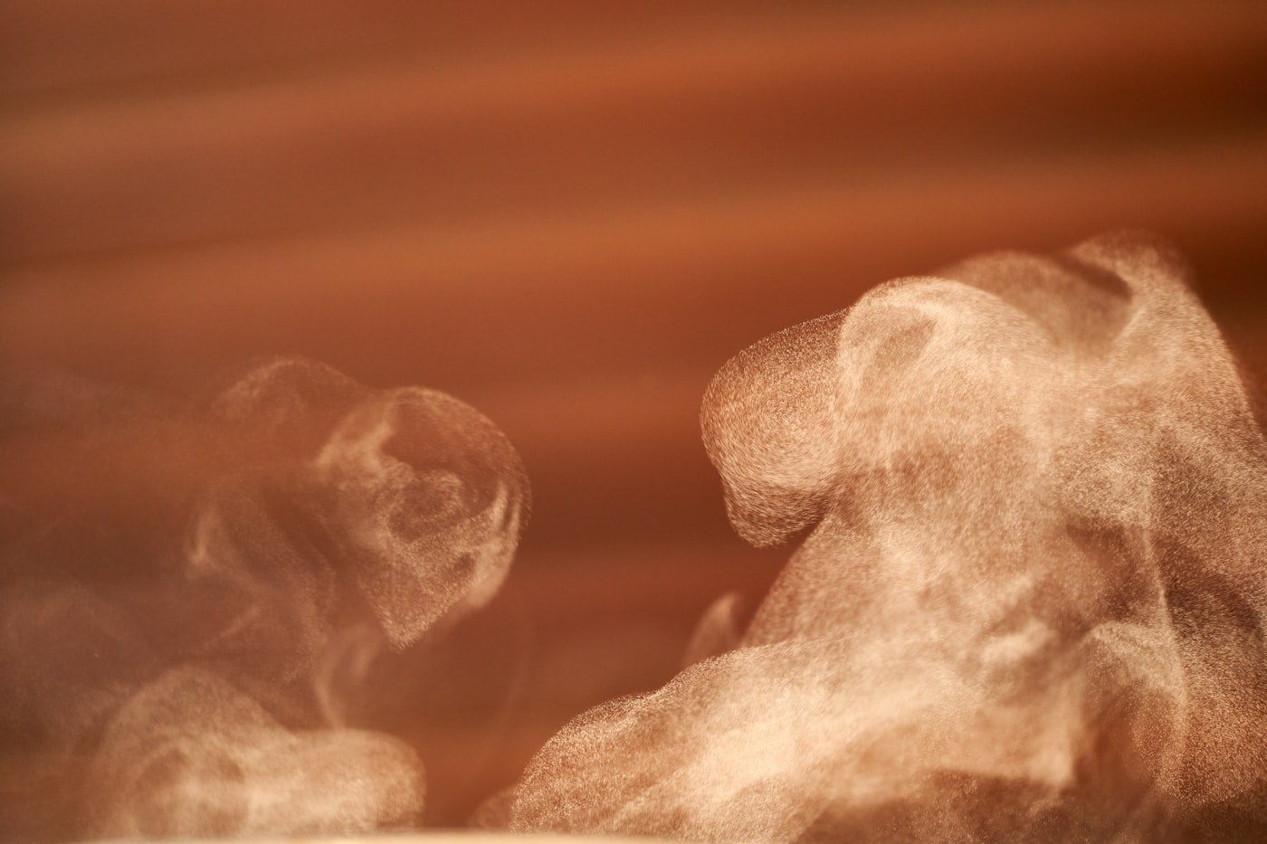 Steam rising from a kopi cup on a kopitiam table